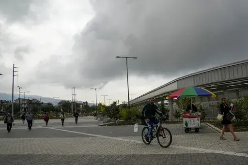 People walk outside of a metro station after a blackout affected the entire country, in Quito, Ecuador, Wednesday, June 19, 2024. In some sectors of the country the outage lasted 20 minutes, but media outlets and social media users reported that the problem continued in most cities. (AP Photo/Dolores Ochoa)