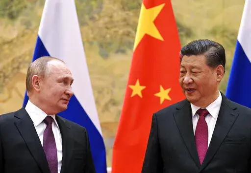 Chinese President Xi Jinping, right, and Russian President Vladimir Putin looks towards each other during their meeting in Beijing, China, on Feb. 4, 2022. China has described reports and images of civilian killings in Ukraine as disturbing, and urged that they be further investigated, even while declining to blame Russia. That's drawn questions about the resiliency of Beijing's support for Moscow, but speculation that it is weakening appears to be misplaced. (Alexei Druzhinin, Sputnik, Kremlin 