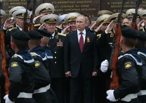 Russian President Vladimir Putin attends a parade marking the Victory Day in Sevastopol, Crimea, on May 9, 2014. Russia's present demands are based on Putin's purported long sense of grievance and his rejection of Ukraine and Belarus as truly separate, sovereign countries but rather as part of a Russian linguistic and Orthodox motherland. (AP Photo/Ivan Sekretarev, File)