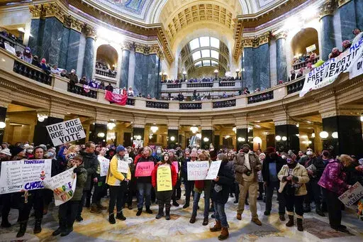 Protesters are seen in the Wisconsin Capitol Rotunda during a march supporting overturning Wisconsin's near total ban on abortion Sunday, Jan. 22, 2023, in Madison, Wis. (AP Photo/Morry Gash)