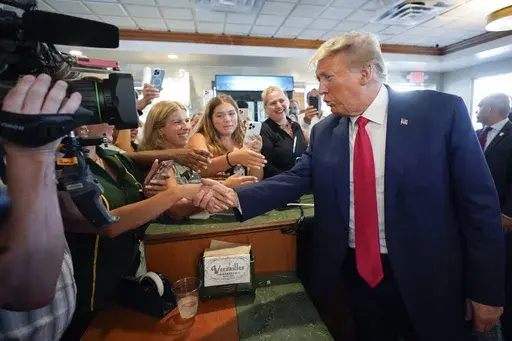 Former President Donald Trump greets supporters at Versailles restaurant on Tuesday, June 13, 2023, in Miami. Trump appeared in federal court Tuesday on dozens of felony charges accusing him of illegally hoarding classified documents and thwarting the Justice Department's efforts to get the records back. (AP Photo/Alex Brandon, File)