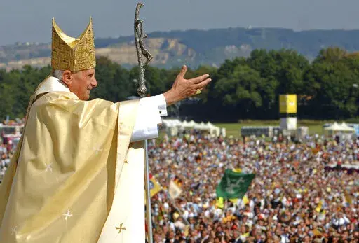Pope Benedict XVI waves to the crowd at the end of a papal Mass at the Islinger field in Regensburg, southern Germany, some 120 kilometers (about 75 miles) northeast of Munich, on Tuesday, Sept. 12, 2006. Pope Benedict XVI leaves his homeland with a complicated legacy: pride in a German pontiff but a church deeply divided over the need for reforms in the wake of a sexual abuse scandal in which his own actions of decades ago were faulted. (AP Photo/Wolfgang Radke, Pool, File)