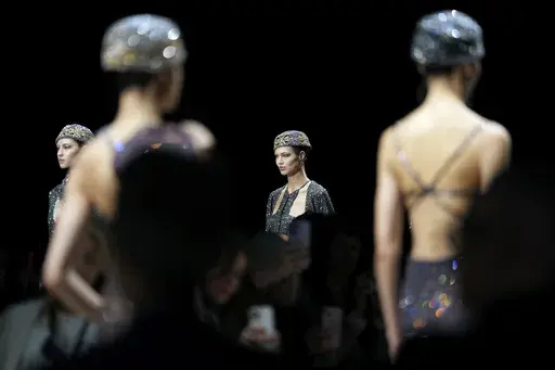 Models wear creations as part of the Giorgio Armani Fall/Winter 2025-2026 Women's collection presented in Milan, Italy, Sunday, March 2, 2025. (AP Photo/Luca Bruno)