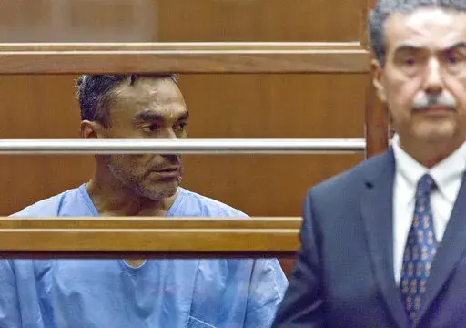 Ramon Escobar, with an unidentified attorney, appears at a hearing in Los Angeles County Superior Court on Sept. 26, 2018. Escobar who pleaded guilty to a series of Southern California attacks that killed five men and injured seven others was sentenced Friday, May 6, 2022, to life in prison without possibility of parole. Ramon Escobar, 50, received multiple life sentences after entering guilty pleas to murder with special circumstances and attempted murder. (AP Photo Damian Dovarganes, File)