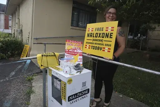 Nonprofit Solutions Oriented Addiction Response West Virginia co-founder Sarah Stone prepares items for the first-ever Appalachian Save a Life Day naloxone distribution event on Monday, Sept. 11, 2023, at the Unitarian Universalist Congregation of Charleston in Charleston, W.Va. (AP Photo/Leah Willingham)
