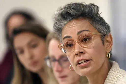 Alison Collins, right, speaks during a meeting in San Francisco, on Sept. 26, 2018. In a city with the lowest percentage of children of all major American cities, school board elections in San Francisco have often been an afterthought. A special election on Feb. 15, 2022, will decide the fate of three school board members, all Democrats, including Collins, in a vote that has divided the famously liberal city. (Liz Hafalia/San Francisco Chronicle via AP)