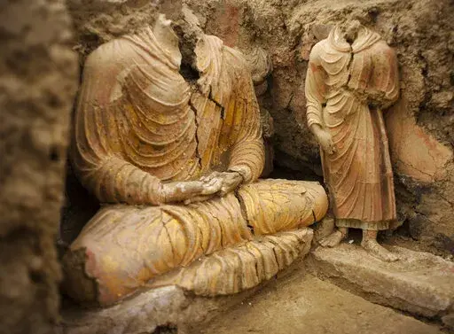 In this photograph made on Tuesday, Oct. 12, 2010 in Mes Aynak valley, south of Kabul, Afghanistan, Buddha statues are seen inside an ancient temple. The valley is the world's second-largest unexploited copper estimated to be worth nearly $1 trillion. (AP Photo/Dusan Vranic, File)