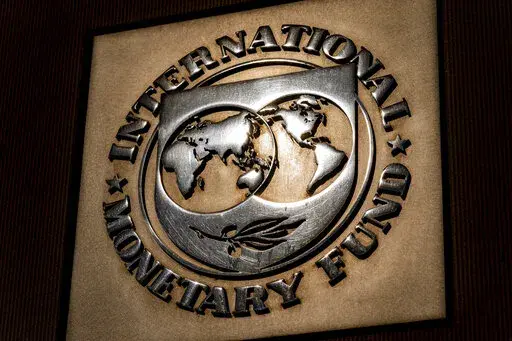 The logo of the International Monetary Fund is visible on their building, April 5, 2021, in Washington. The IMF is facing pressure to eliminate, or at least, reevaluate how it imposes fees on loans it disperses to needy countries like war-torn Ukraine — which is one of the fund's biggest borrowers. (AP Photo/Andrew Harnik)