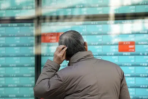 A person looks at an electronic stock board showing Japan's stocks' prices at a securities firm in Tokyo, Dec. 21, 2023. Asian shares powered higher on Thursday, Dec. 28 with Chinese benchmarks up more than 1%, after Wall Street logged modest gains in this holiday-shortened week. (AP Photo/Eugene Hoshiko, File)