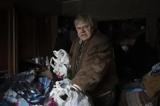 Serhii Slobodiannyk, 63, stands inside of his apartment that was damaged as a result of Russia's attack on Jan. 2 in Kyiv, Ukraine, Wednesday, Jan. 3, 2024. "Everything I worked for over 30 years was destroyed in less than a second," he says. (AP Photo/Hanna Arhirova)