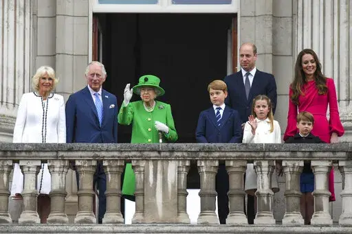 From left,  Camilla, Duchess of Cornwall Prince Charles, Queen Elizabeth II, Prince George, Prince William, Princess Charlotte, Prince Louis and Kate, Duchess of Cambridge stand on the balcony, at the end of the Platinum Jubilee Pageant held outside Buckingham Palace, in London, Sunday June 5, 2022, on the last of four days of celebrations to mark the Platinum Jubilee. The pageant will be a carnival procession up The Mall featuring giant puppets and celebrities that will depict key moments from 