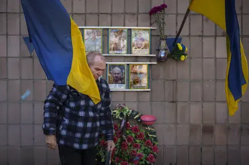 Oleksandr Turovskyi, father of Sviatoslav Turovskyi, in the top right picture, one of the men killed by Russian forces near the building on Yablunska street, leaves after bringing fresh flowers to the place where his son's body was abandoned, in Bucha, Ukraine, Tuesday, March 26, 2024. Days after Russian forces withdrew from the area in late March, in the dramatic first weeks of the full-scale invasion, a photo taken by AP Photographer Vadim Ghirda revealed what happened to the eight men. (AP Ph