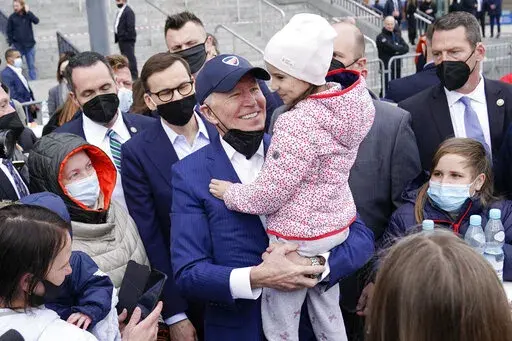 President Joe Biden meets with Ukrainian refugees during a visit to PGE Narodowy Stadium, March 26, 2022, in Warsaw. The Biden administration is making it easier for refugees fleeing Russia’s war on Ukraine to come to the United States from Europe while trying to shut down an informal route through Northern Mexico that has emerged in recent weeks.  (AP Photo/Evan Vucci, File)