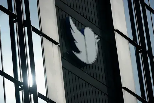 A Twitter logo hangs outside the company's offices in San Francisco, on Dec. 19, 2022. The Canadian Broadcasting Corporation paused its use of Twitter on Monday, April 17, 2023, after the social media platform owned by Elon Musk stamped CBC’s account with a label the public broadcaster says is intended to undermine its credibility. (AP Photo/Jeff Chiu, File)