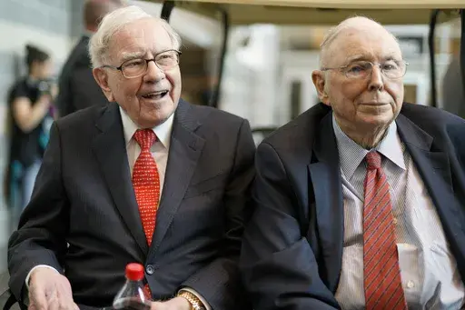 FILE- In this May 3, 2019 file photo, Berkshire Hathaway Chairman and CEO Warren Buffett, left, and Vice Chairman Charlie Munger, briefly chat with reporters before Berkshire Hathaway's annual shareholders meeting. Buffett credited his longtime partner — the late Charlie Munger — with being the architect of the Berkshire Hathaway conglomerate he’s received the credit for leading and warned shareholders in his annual letter not to listen to Wall Street pundits or financial advisors who urge