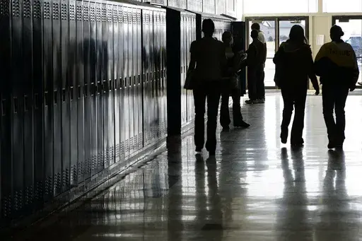 Students walk down a hallway at a high school in Iowa on Tuesday, Dec. 19, 2006. In 2024, bills in the Iowa, Kentucky, Missouri and West Virginia legislatures would require public school students to watch a fetal development video similar to one created by an anti-abortion group. The proposed legislation mirrors a law passed in North Dakota last year. (Scott Morgan/The Hawk Eye via AP)
