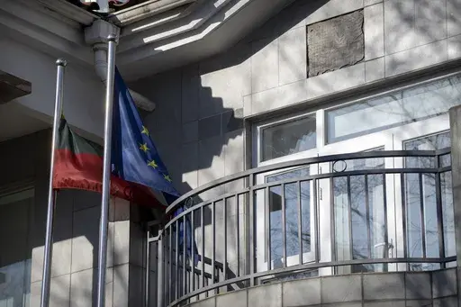 Lithuanian and European Union flags fly outside the Lithuanian Embassy in Beijing, Dec. 16, 2021. The U.S. State Department has set up an eight-person team known as the "firm" to provide help to countries cut off from Chinese trade. The team emerged after Washington stepped in to help Lithuania when the northern European country found its cargo shipments to and from China stranded two years ago during a feud over Taiwan. (AP Photo/Mark Schiefelbein)