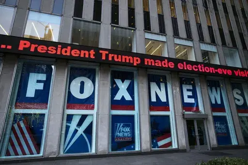 A headline about President Donald Trump is displayed outside Fox News studios in New York on Nov. 28, 2018. Dominion Voting Systems' defamation case against Fox News over its airing of false allegations about the 2020 presidential election will go to trial after a Delaware judge allowed a jury to decide whether the conservative network aired the claims with actual malice, the standard for proving libel. (AP Photo/Mark Lennihan, File)