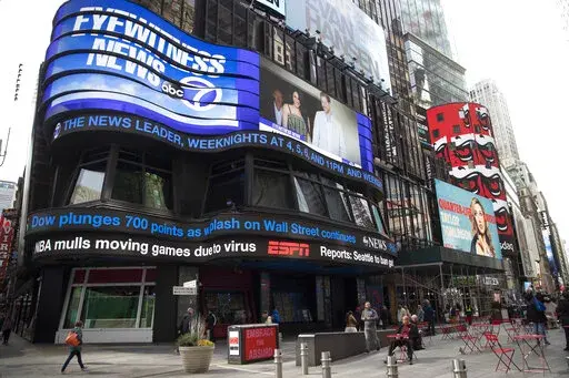 An electronic ticker displays news Wednesday, March 11, 2020, in New York's Times Square. A new survey released Wednesday, Feb. 15, 2023, shows fully half of Americans indicate they believe national news organizations intend to mislead, misinform or persuade the public to adopt a point of view. (AP Photo/Mary Altaffer, File)