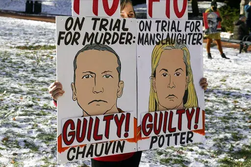 A demonstrator holds up "GUILTY" signs at the Hennepin County Government Center, Dec. 23, 2021, in Minneapolis, where jurors found former suburban Minneapolis police officer Kim Potter guilty of first degree and second degree manslaughter in the death of motorist Daunte Wright during a traffic stop. Data show it's rare for police officers to be convicted of on-duty killings. But three recent convictions of police officers in Minnesota have some people wondering whether that's changing. (AP Photo