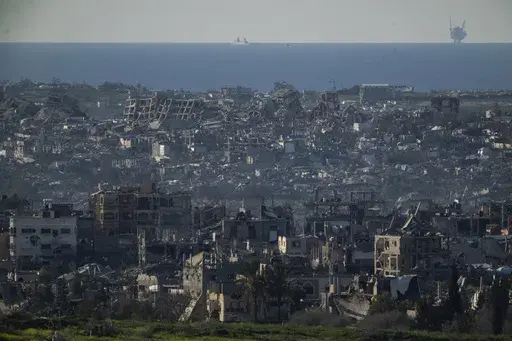Buildings destroyed during the Israeli air and ground offensive stand in the Gaza Strip are seen from southern Israel, Sunday, March 2, 2025. (AP Photo/Leo Correa)