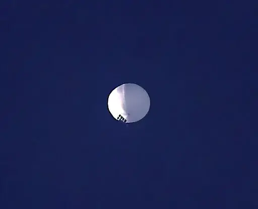 ADDS PENTAGON RESPONSE THAT IT WOULD NOT CONFIRM - A high altitude balloon floats over Billings, Mont., on Wednesday, Feb. 1, 2023. The U.S. is tracking a suspected Chinese surveillance balloon that has been spotted over U.S. airspace for a couple days, but the Pentagon decided not to shoot it down due to risks of harm for people on the ground, officials said Thursday, Feb. 2, 2023. The Pentagon would not confirm that the balloon in the photo was the surveillance balloon. (Larry Mayer/The Billin