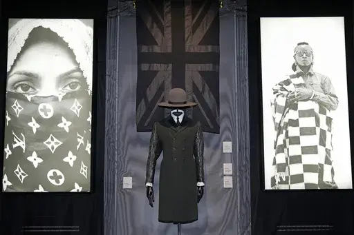 A black union jack shawl, Madhatter crown hat and Rudie coat designed by London-based art collective Art Comes First, are displayed during a preview of the exhibition titled "The Missing Thread: Untold Stories of Black British Fashion", at Somerset House, in London, Tuesday, Sept. 19, 2023. A new exhibition is opening in London to chart for the first time the contributions Black British culture made to U.K. fashion and design history and to celebrate Black designers who have not received public 