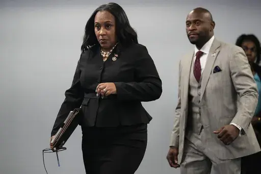 Fulton County District Attorney Fani Willis, followed by special prosecutor Nathan Wade, right, arrives for a news conference at the Fulton County Government Center, Monday, Aug. 14, 2023, in Atlanta. Willis acknowledged in a court filing on Friday, Feb. 2, 2024, having a “personal relationship” with Wade, a special prosecutor she hired for the Georgia election interference case against former President Donald Trump, but argued there are no grounds to dismiss the case or to remove her from t