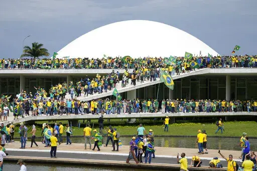 Protesters, supporters of Brazil's former President Jair Bolsonaro, storm the the National Congress building in Brasilia, Brazil, Jan. 8, 2023. Brazil’s federal police searched the home of a nephew of Bolsonaro on Friday, Jan. 27, 2023, in connection with the Jan. 8 storming of government buildings in the capital by far-right protesters. (AP Photo/Eraldo Peres, File)
