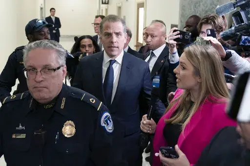 Hunter Biden, President Joe Biden's son, center, leaves a House Oversight Committee hearing as Republicans are taking the first step toward holding him in contempt of Congress, Wednesday, Jan. 10, 2024, on Capitol Hill in Washington. (AP Photo/Jose Luis Magana)