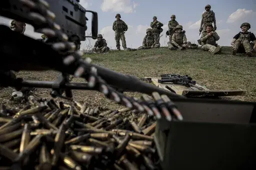 In this provided by Ukraine's 24th Mechanized Brigade press service, servicemen of 3rd mechanized battalion, practice on the training ground at an undisclosed location in the east of Ukraine, Thursday, March 27, 2025. (Oleg Petrasiuk/Ukraine's 24th Mechanized Brigade via AP)