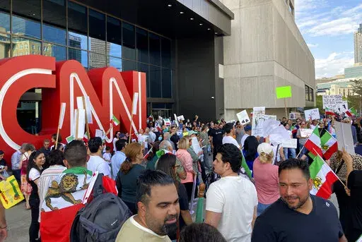 Iranian Americans demonstrate in support of protesters in Iran on Sunday, Sept. 25, 2022, in Atlanta The demonstration comes amid violent unrest in Iran triggered by the death of a young woman in police custody. (AP Photo/Jeff Amy)