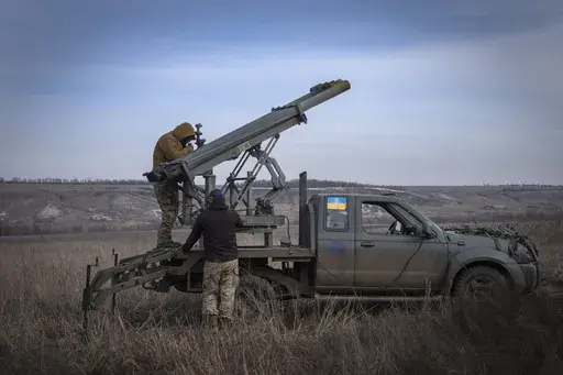 Ukrainian soldiers from The 56th Separate Motorized Infantry Mariupol Brigade prepare to fire a multiple launch rocket system based on a pickup truck towards Russian positions at the front line, near Bakhmut, Donetsk region, Ukraine, March 5, 2024. Senior U.S. defense officials said Tuesday, March 12, that the Pentagon will rush about $300 million in weapons to Ukraine after finding some cost savings in its contracts, even though the military remains deeply overdrawn. (AP Photo/Efrem Lukatsky, F