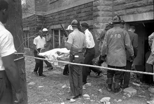 Firefighters and ambulance attendants remove a covered body from the 16th Street Baptist Church in Birmingham, Ala., Sept. 15, 1963, after a deadly explosion detonated by members of the Ku Klux Klan during services. Alabama on Friday, Sept. 15, 2023, will mark the 60th anniversary of the bombing that killed four girls. Lisa McNair, the sister of one of the victims, said as the anniversary is remembered, she hoped people will think about what they can do to combat hate. (AP Photo, File)