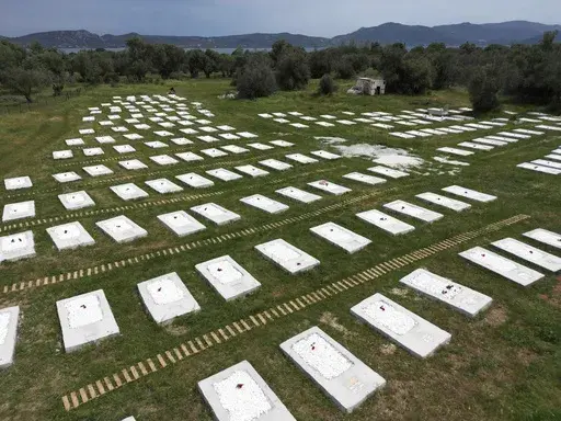 A cemetery is seen from above at Kato Tritos village on the northeastern Aegean Sea island of Lesbos, Greece, on Wednesday, April 17, 2024. After years of neglect, a primitive burial ground for refugees who died trying to reach Greece's island of Lesbos has been cleaned up and redesigned to provide a dignified resting place for the dead. (AP Photo/Panagiotis Balaskas)