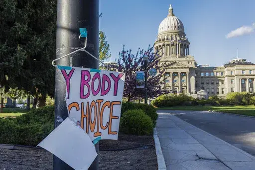 A sign reading "My body, my Choice," is taped to a hanger taped to a streetlight in front of the Idaho State Capitol Building on May 3, 2022. In Idaho, the U.S. Department of Justice has sued the Republican-led state over its abortion trigger law after arguing it violates a federal law requiring Medicaid-funded hospitals to provide "stabilizing treatment" to patients experiencing medical emergencies. (Sarah A. Miller/Idaho Statesman via AP, File)