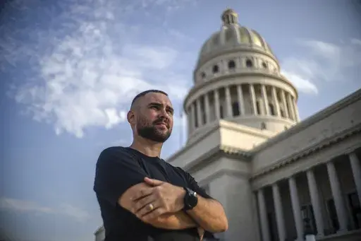 Elian González poses for a portrait in front of the Capitolio in Havana, Cuba, Thursday, June 27, 2023. Twenty three years after González became the center of a dramatic diplomatic custody battle between Cuba and the United States, the young Cuban is now headed to his country’s congress with hopes of representing his people at a time of record migration and heightened tension between the two seaside neighbors. (AP Photo/Ramon Espinosa)