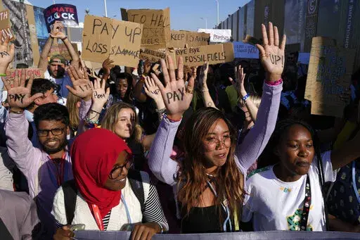 Mitzi Jonelle Tan, center, of the Philippines, participates in a demonstration at the COP27 U.N. Climate Summit, Nov. 18, 2022, in Sharm el-Sheikh, Egypt. (AP Photo/Peter Dejong, File)