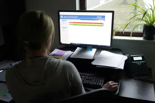 Case work supervisor Jessie Schemm looks over the first screen of software used by workers who field calls at an intake call screening center for the Allegheny County Children and Youth Services, in Penn Hills, Pa. The Justice Department has been scrutinizing a controversial artificial intelligence tool used by a Pittsburgh-area child protective services agency following concerns that it could result in discrimination against families with disabilities, The Associated Press has learned. (AP Phot