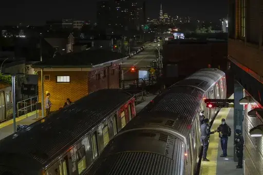 New York Police officers clear a train at the Coney Island Stillwell Avenue Terminal, May 5, 2020, in the Brooklyn borough of New York. (AP Photo/Frank Franklin II, file)