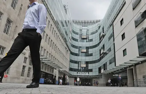 A view of the main entrance to the headquarters of the publicly funded BBC in London, Wednesday, July 19, 2017. Senior British politicians on Sunday, July 9, 2023 called on the BBC to rapidly investigate a complaint that a leading presenter paid a teenager for explicit photos. The publicly funded national broadcaster is under pressure after The Sun newspaper reported allegations that the male presenter gave a youth 35,000 pounds ($45,000) starting in 2020 when the young person was 17. (AP Photo/