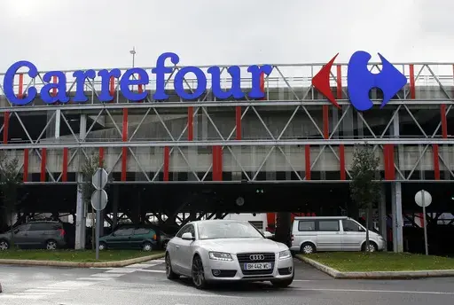 Car leaves a Carrefour supermarket in Anglet, southwestern France, on Jan.23, 2018. Global supermarket chain Carrefour will stop selling PepsiCo products in its stores in France, Belgium, Spain and Italy over price increases for popular items like Lay's potato chips, Quaker Oats, Lipton tea and its namesake soda. (AP Photo/Bob Edme, File)