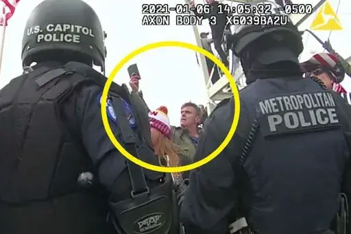 This image from Washington Metropolitan Police Department body-worn video, released and annotated by the Justice Department in the statement of facts supporting an arrest warrant for Jay James Johnston, shows Johnston, circled in yellow, at the U.S. Capitol on Jan. 6, 2021, in Washington. Johnston, the actor known for his roles on the comedy television shows "Bob's Burgers" and "Mr. Show with Bob and David" has been arrested on charges that he joined a mob of Donald Trump supporters in confronti