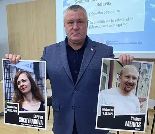 In this handout photo from the Viasna Human Rights Center, Leanid Sudalenka, an activist from Belarus, holds portraits of imprisoned journalists Larysa Shchyrakova and Yauhen Merkis, in Belostok, Poland, Sunday, Nov. 5, 2023. Sudalenka, who was imprisoned for three years in Belarus, said authorities there hold political prisoners in conditions amounting to "torture." He told The Associated Press that when he was in a Belarusian penal colony, he nearly died from COVID-19 and a lack of medical car