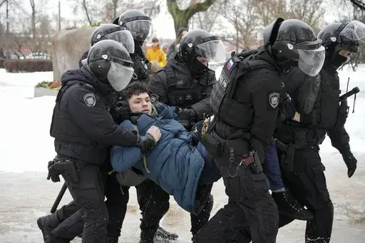 Police detain a man trying to lay flowers to honor Alexei Navalny at a monument in St. Petersburg, Russia, to victims of Soviet repression, on Saturday, Feb. 17, 2024. Over the last decade, Vladimir Putin's Russia evolved from a country that tolerates at least some dissent to one that ruthlessly suppresses it. Arrests, trials and long prison terms — once rare — are commonplace. (AP Photo, File)
