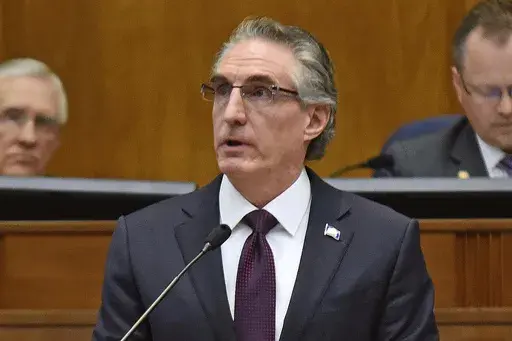 North Dakota Gov. Doug Burgum delivers his budget address before a joint session of the North Dakota Legislature in Bismarck, N.D., Dec. 5, 2018. Burgum signed a bill Monday, April 24, 2023, that limits access to bathrooms, locker rooms and shower rooms for transgender and gender-nonconforming people in several state facilities. (Tom Stromme/The Bismarck Tribune via AP, File)