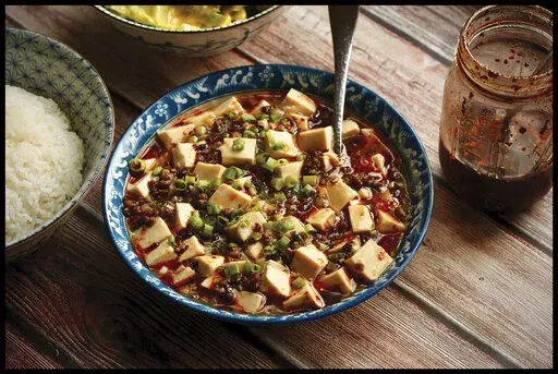 This image shows a recipe for Japanese-Style Mapo Tofu from the cookbook "The Wok: Recipies and Techniques," by J. Kenji López-Alt. (J. Kenji López-Alt/W. W. Norton & Company via AP)