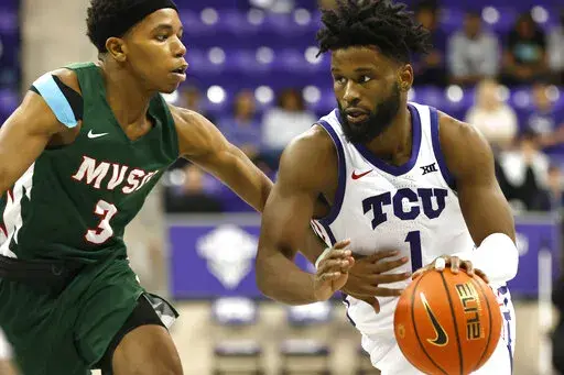 TCU guard Mike Miles Jr. (1) handles the ball as Mississippi Valley State guard Kadar Waller (3) defends during the second half of an NCAA college basketball game, Sunday, Dec. 18, 2022, in Fort Worth, Texas. (AP Photo/Ron Jenkins)