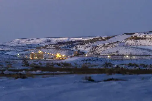 Lights illuminate a coal mine at twilight, Jan. 13, 2022, in Kemmerer, Wyo. With the nearby coal-fired Naughton Powerplant being decommissioned in 2025, the fate of the coal mine and its workers is uncertain. More than 500 days into his presidency, Joe Biden's hope for saving the Earth from the most devastating effects of climate change may not be dead. But it's not far from it after a Supreme Court ruling not only limited the Environmental Protection Agency's ability to regulate pollution by po