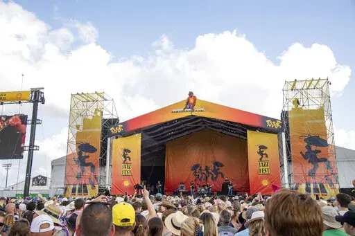 Festivalgoers are seen at the New Orleans Jazz and Heritage Festival, on Thursday, May 5, 2022, in New Orleans. (Photo by Amy Harris/Invision/AP)